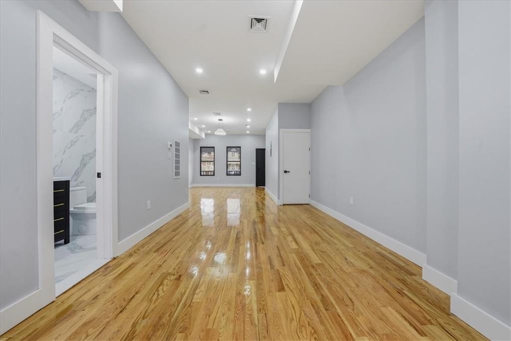 2862 Briggs Avenue Bronx, NY 10458 - Photo 31 of 38 a view of empty room with wooden floor