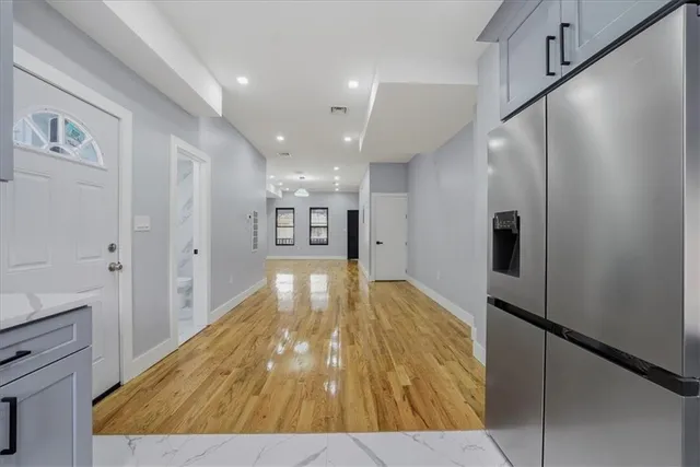 a view of a hallway with wooden floor