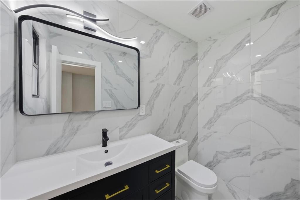 2862 Briggs Avenue Bronx, NY 10458 - Photo 34 of 38 a bathroom with a sink a toilet and shower
