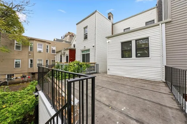 a view of a house with wooden fence