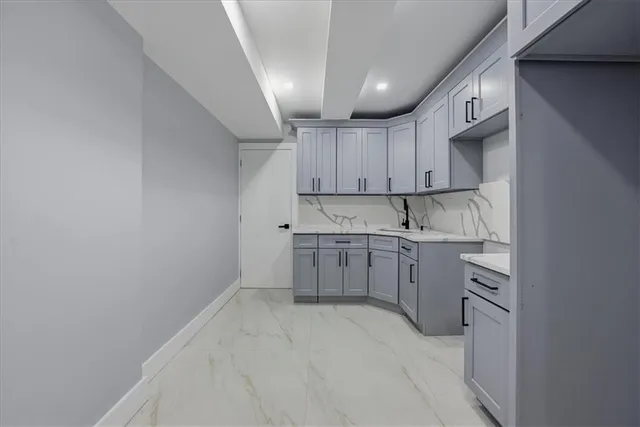 a kitchen with cabinets appliances a sink and a window