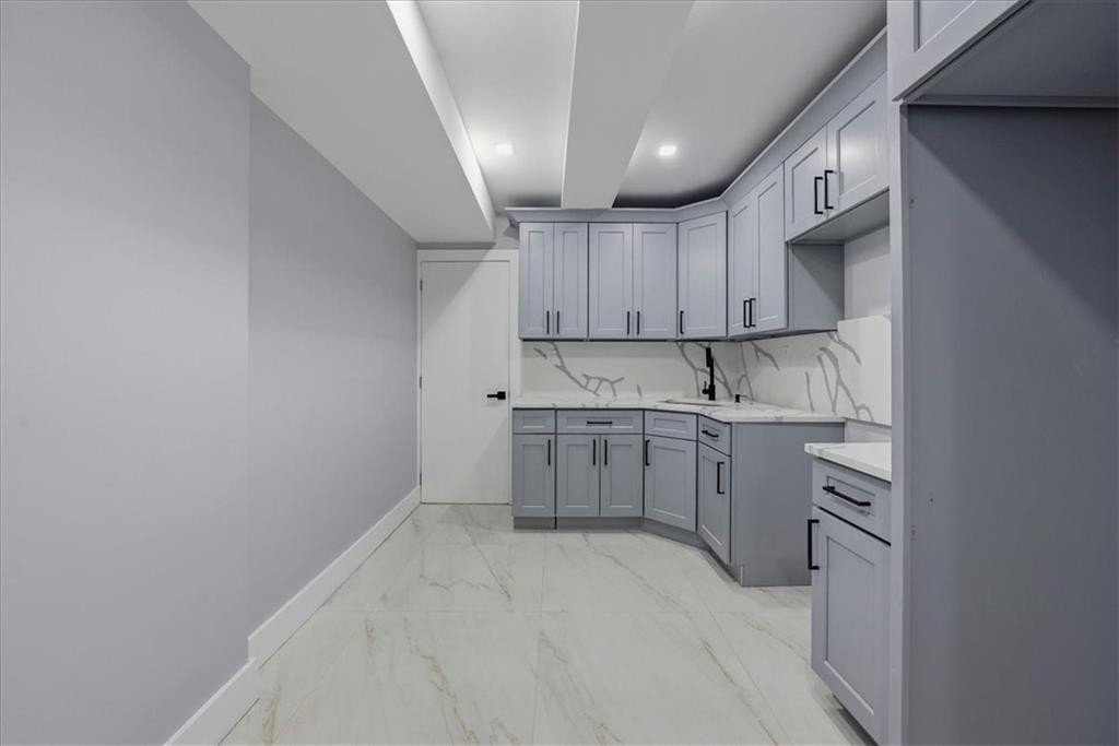2862 Briggs Avenue Bronx, NY 10458 - Photo 10 of 38 a kitchen with cabinets appliances a sink and a window