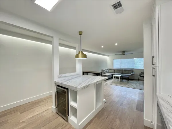 a open kitchen with stainless steel appliances granite countertop a stove and a refrigerator