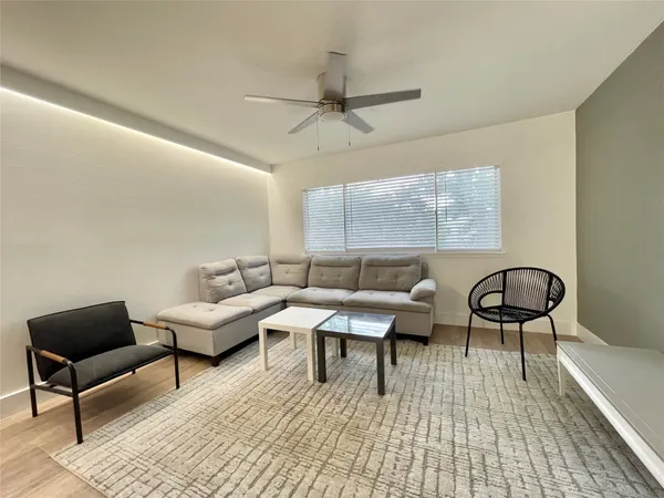 a living room with furniture and a rug
