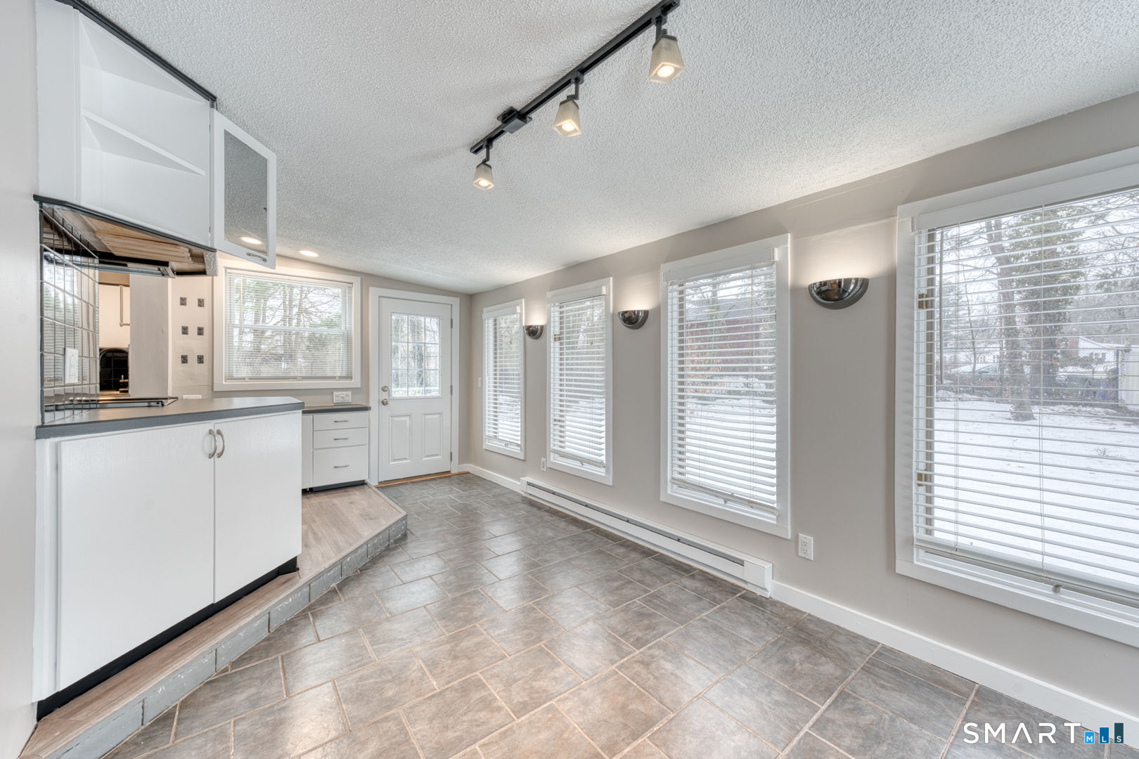 11 Charter Road Wethersfield, CT 06109 - Photo 11 of 40 a large white kitchen with window and stainless steel appliances
