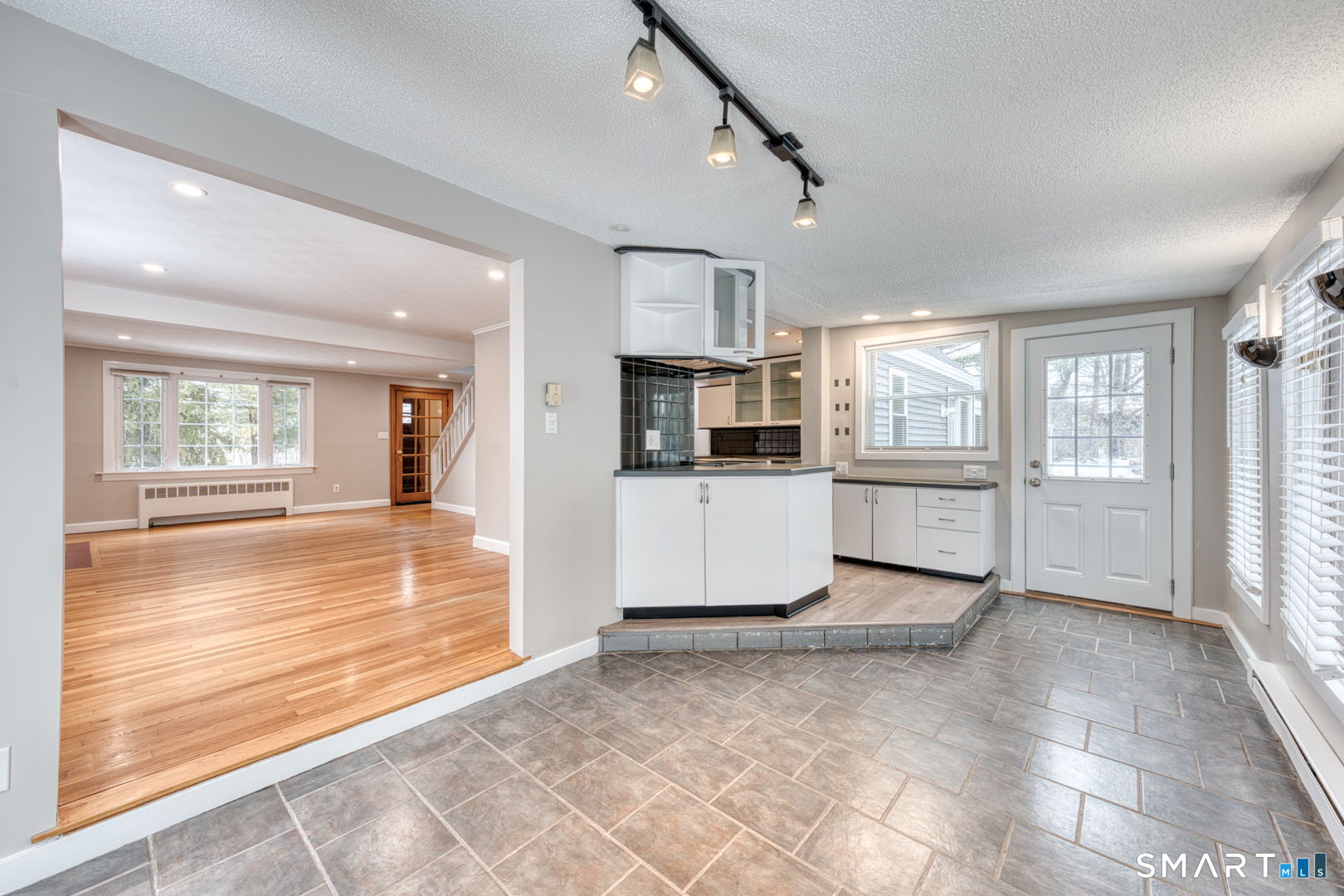 11 Charter Road Wethersfield, CT 06109 - Photo 12 of 40 a view of a kitchen with wooden floor and windows