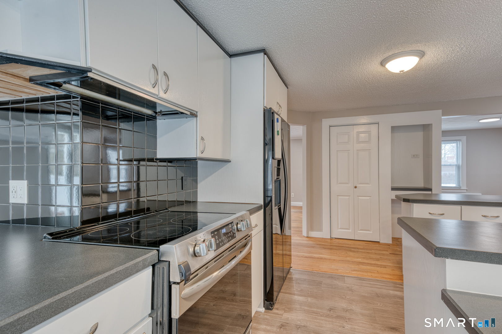 11 Charter Road Wethersfield, CT 06109 - Photo 14 of 40 a kitchen that has a sink and a stove