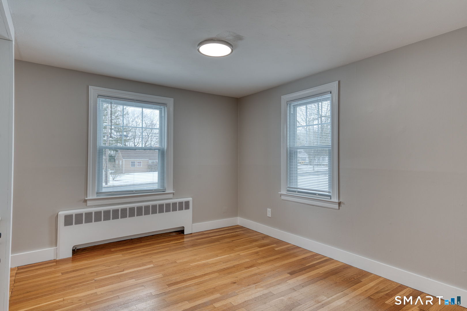11 Charter Road Wethersfield, CT 06109 - Photo 20 of 40 an empty room with wooden floor and windows
