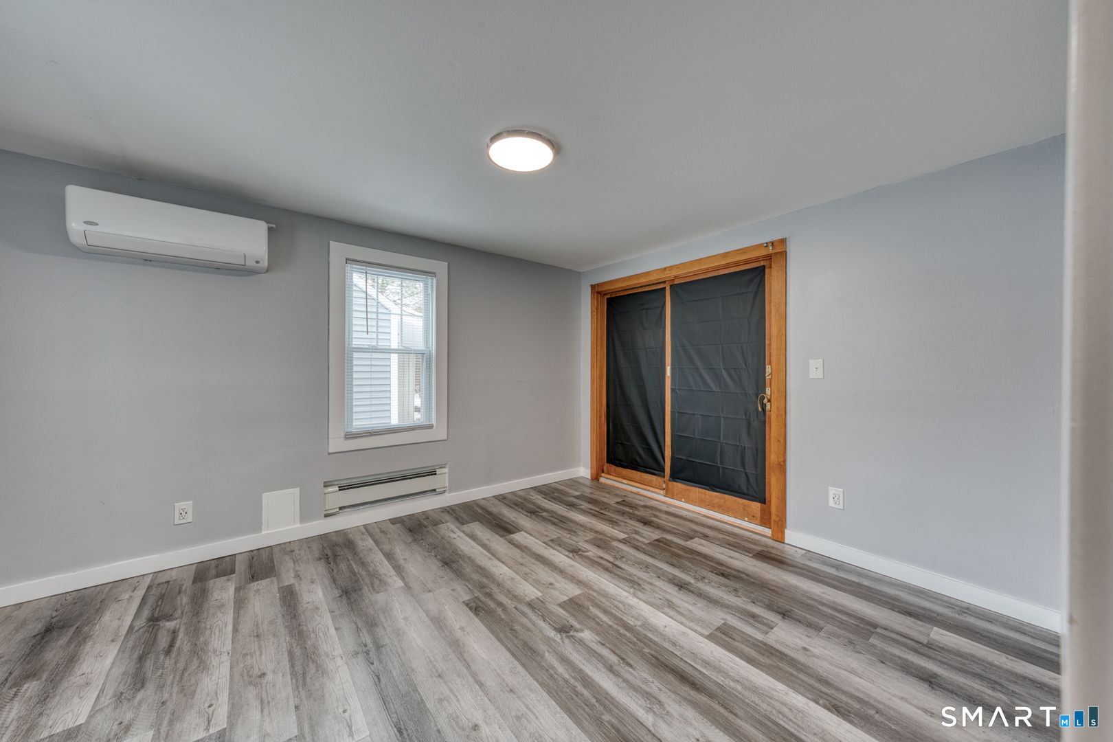 11 Charter Road Wethersfield, CT 06109 - Photo 23 of 40 a view of an empty room with wooden floor and a window