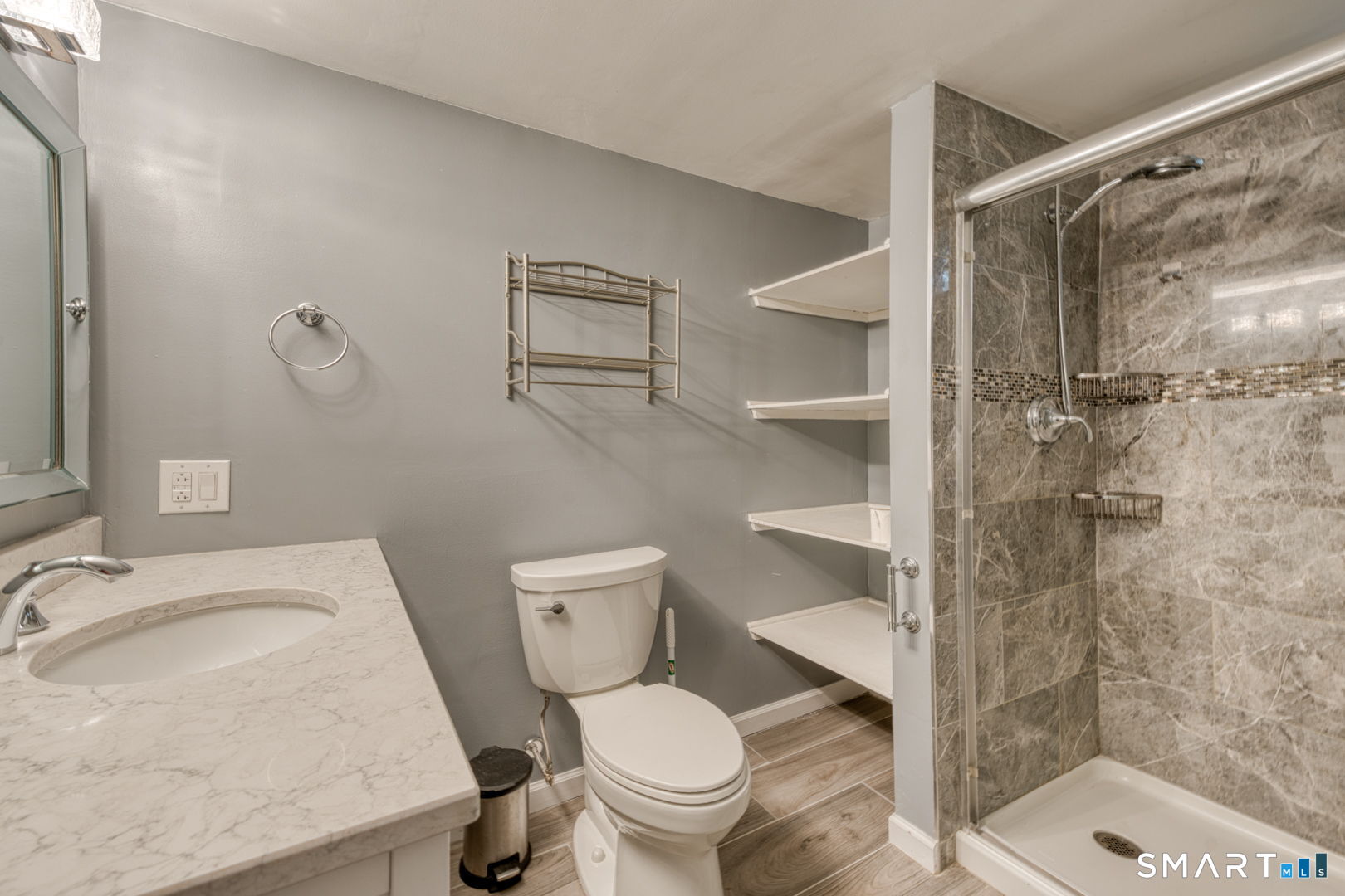 11 Charter Road Wethersfield, CT 06109 - Photo 38 of 40 a white toilet sitting next to a bathroom sink and a shower