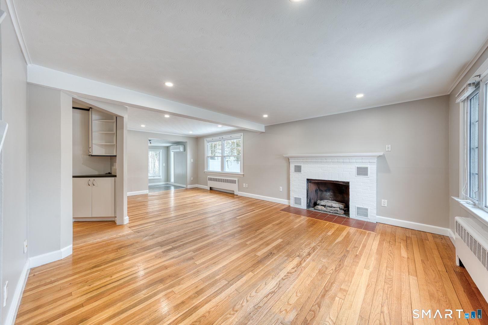 11 Charter Road Wethersfield, CT 06109 - Photo 5 of 40 a view of empty room with wooden floor and fireplace