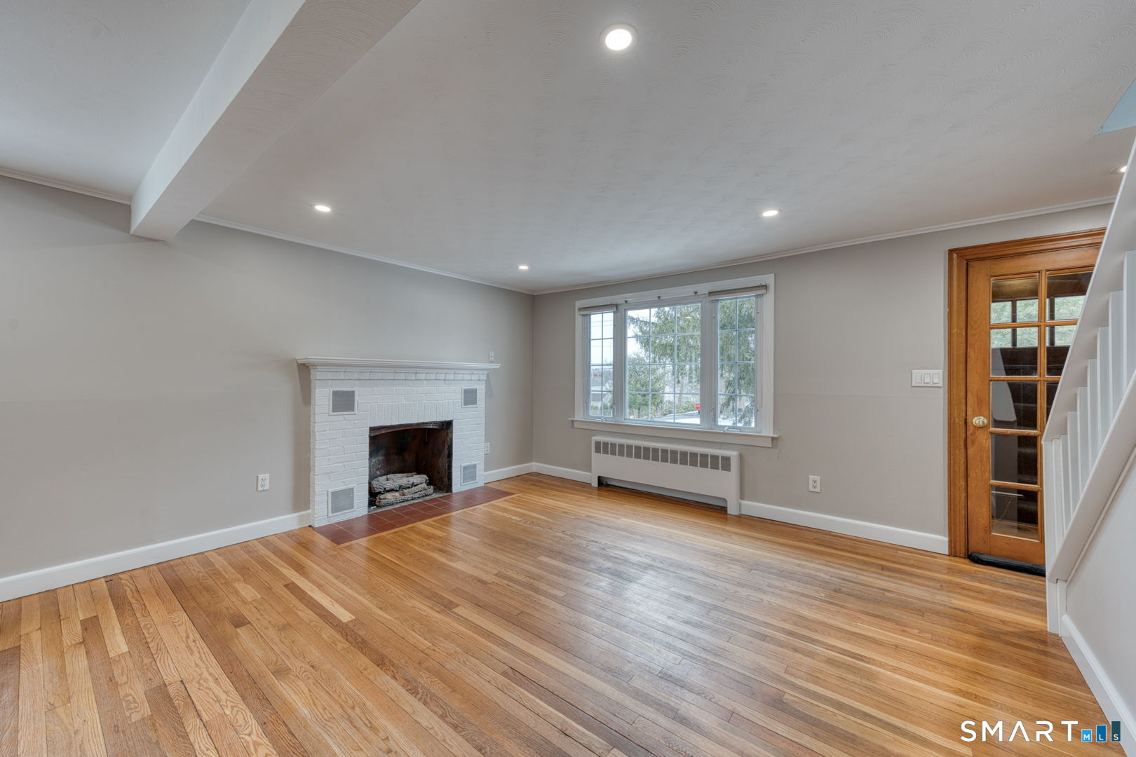 11 Charter Road Wethersfield, CT 06109 - Photo 7 of 40 an empty room with windows and a fireplace