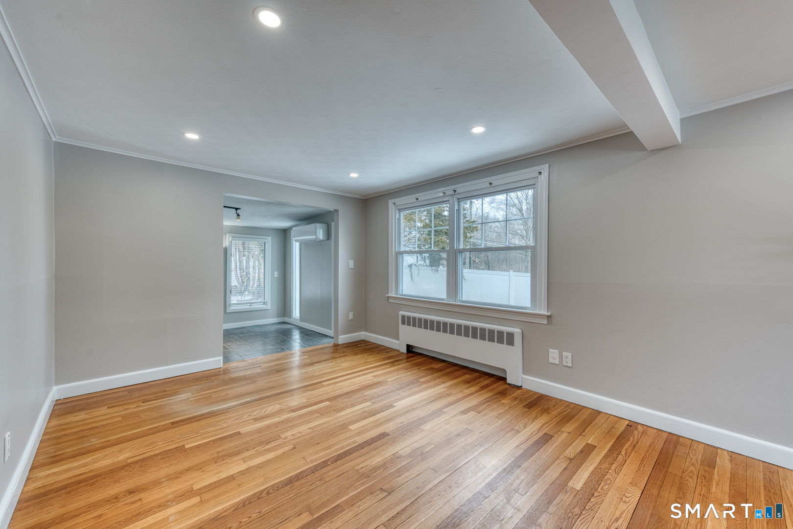 11 Charter Road Wethersfield, CT 06109 - Photo 8 of 40 a view of an empty room with wooden floor and a window