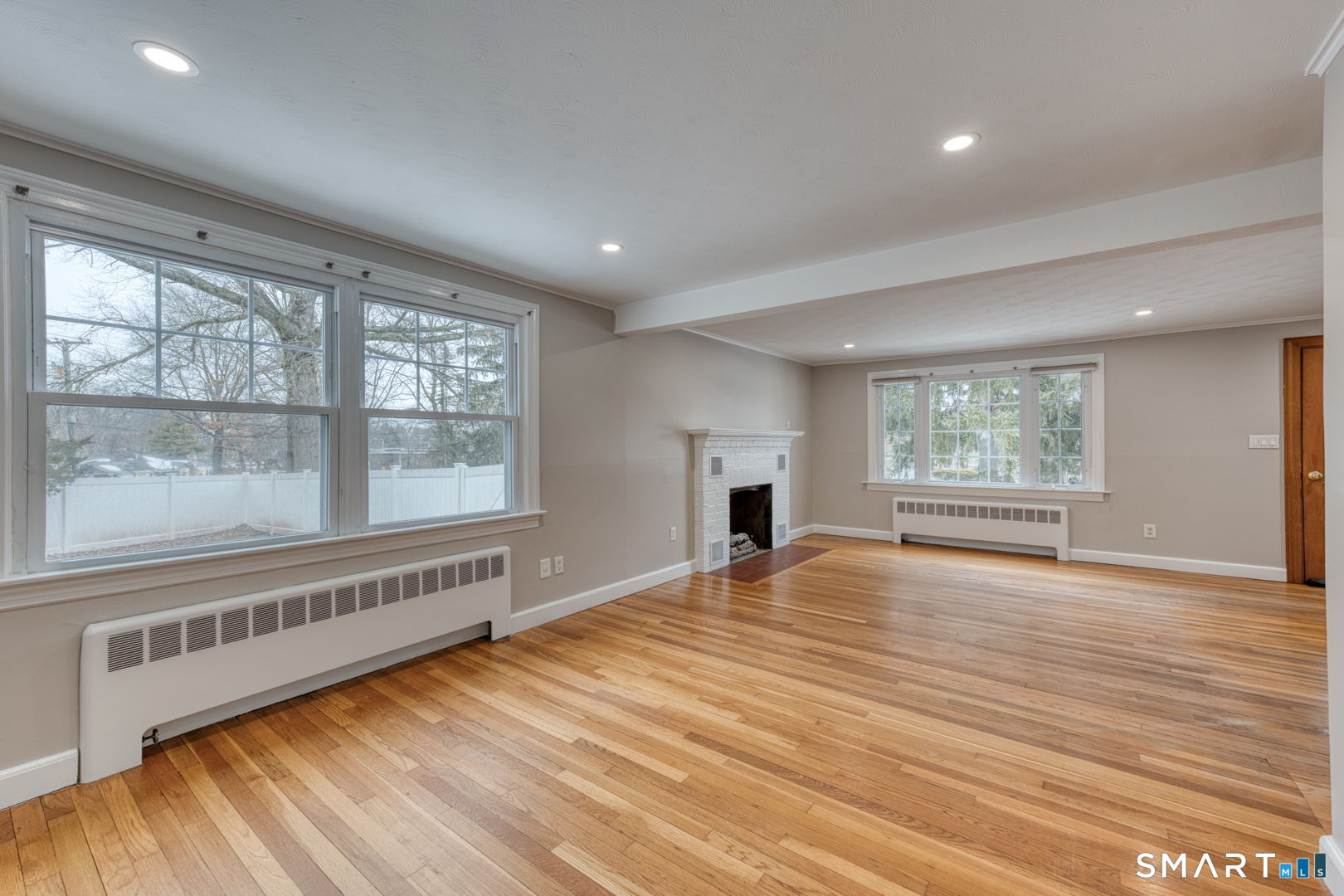 11 Charter Road Wethersfield, CT 06109 - Photo 9 of 40 a view of an empty room with wooden floor and a window