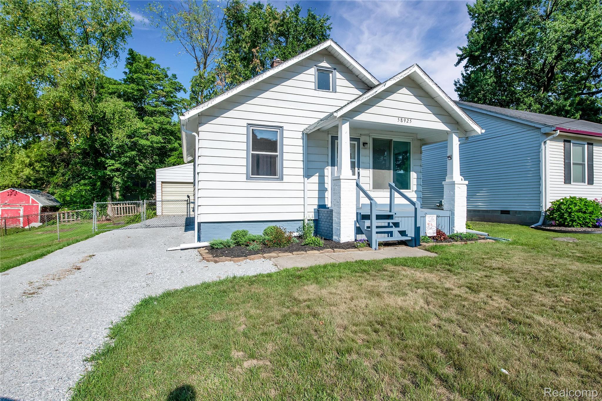 58925 Haven Ridge Road New Haven, MI 48048 - Photo 1 of 22 Bungalow-style house featuring an outdoor structure and covered porch