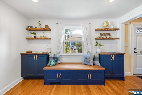 a view of a dining room with furniture a chandelier and wooden floor