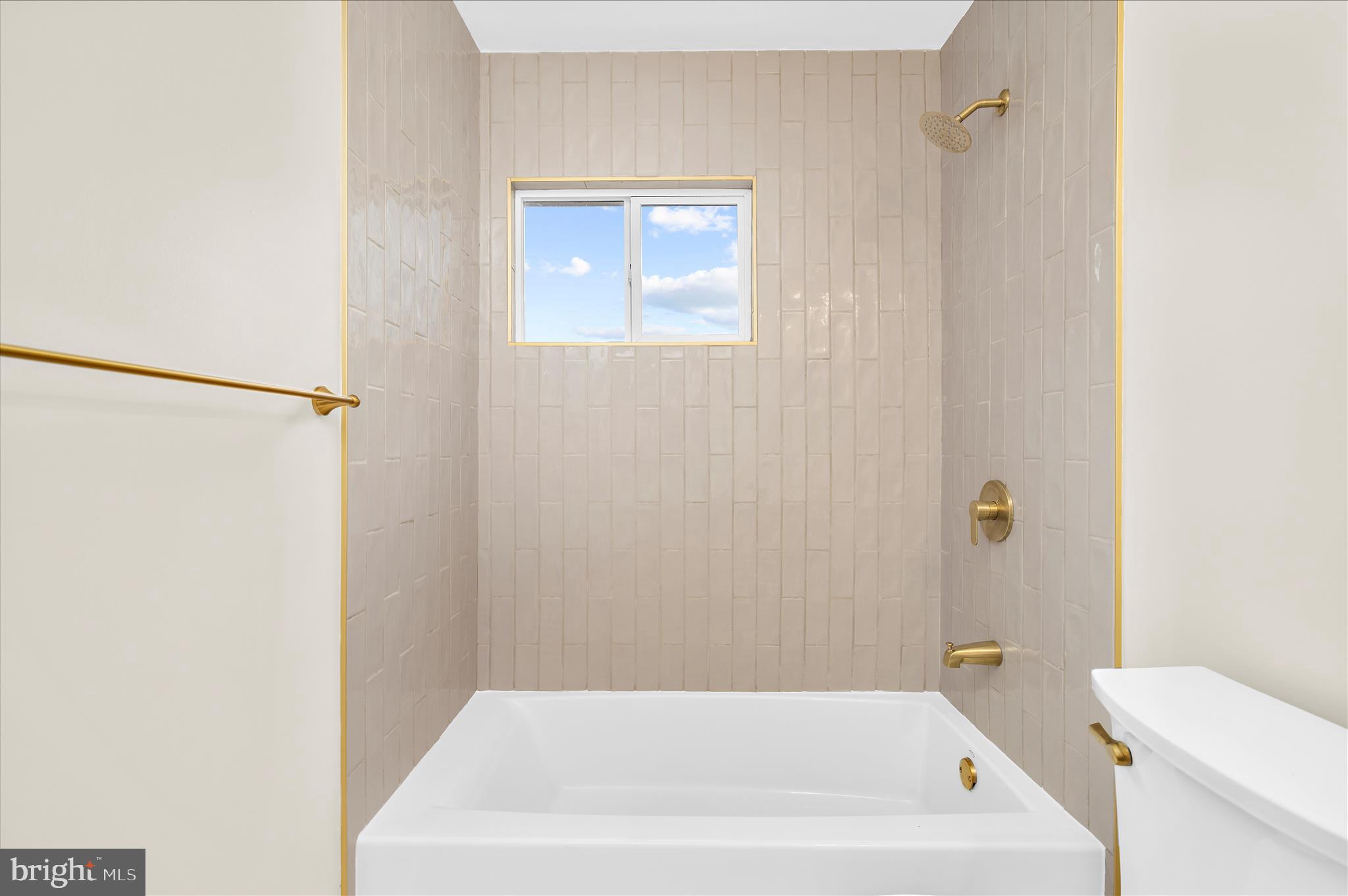 7831 Overhill Road Glen Burnie, MD 21060 - Photo 15 of 57 a bathroom with a bathtub and a toilet