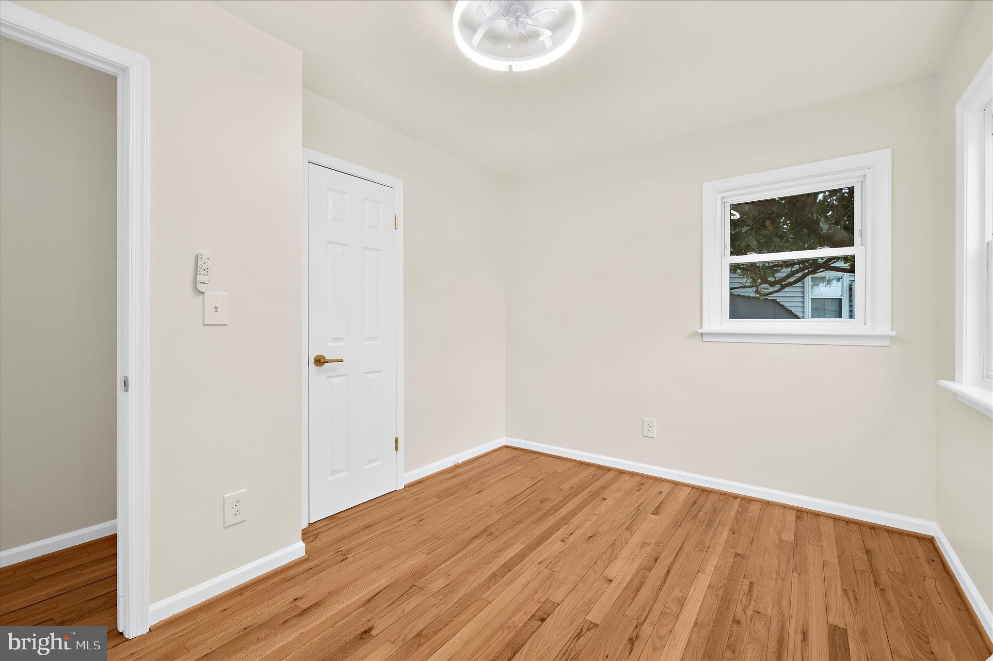 7831 Overhill Road Glen Burnie, MD 21060 - Photo 17 of 57 an empty room with wooden floor and windows