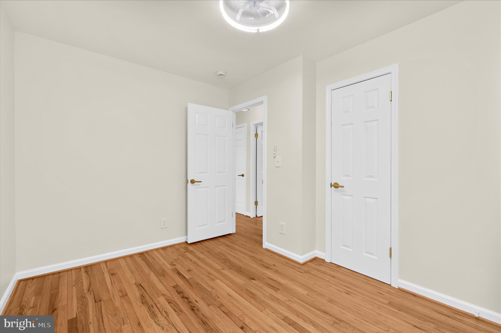 7831 Overhill Road Glen Burnie, MD 21060 - Photo 18 of 57 a view of an empty room with wooden floor and a window