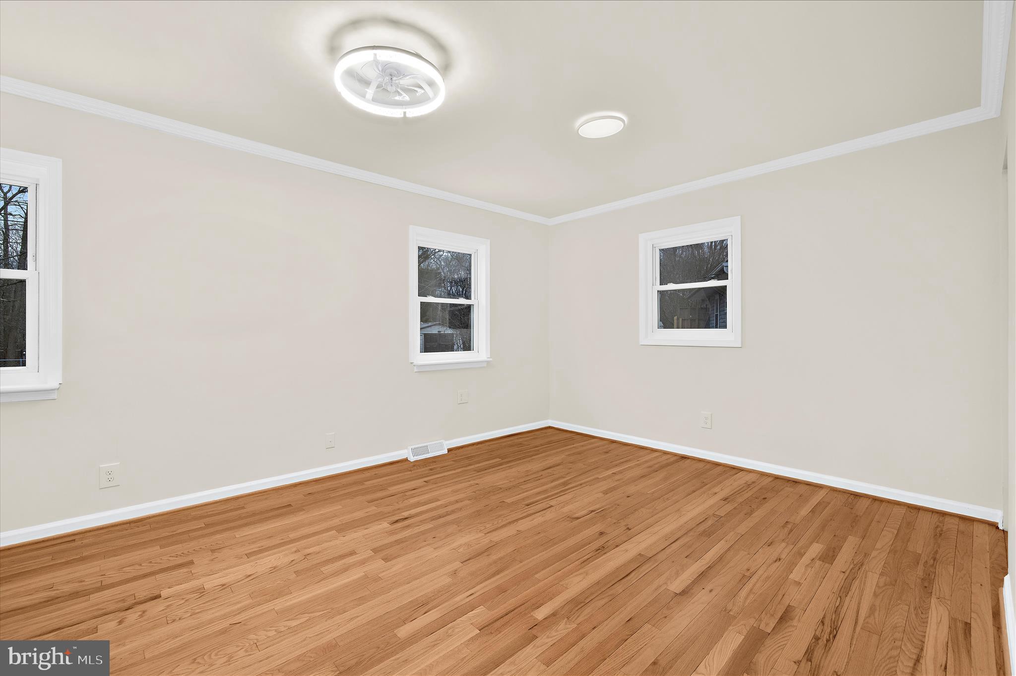 7831 Overhill Road Glen Burnie, MD 21060 - Photo 19 of 57 an empty room with wooden floor and windows