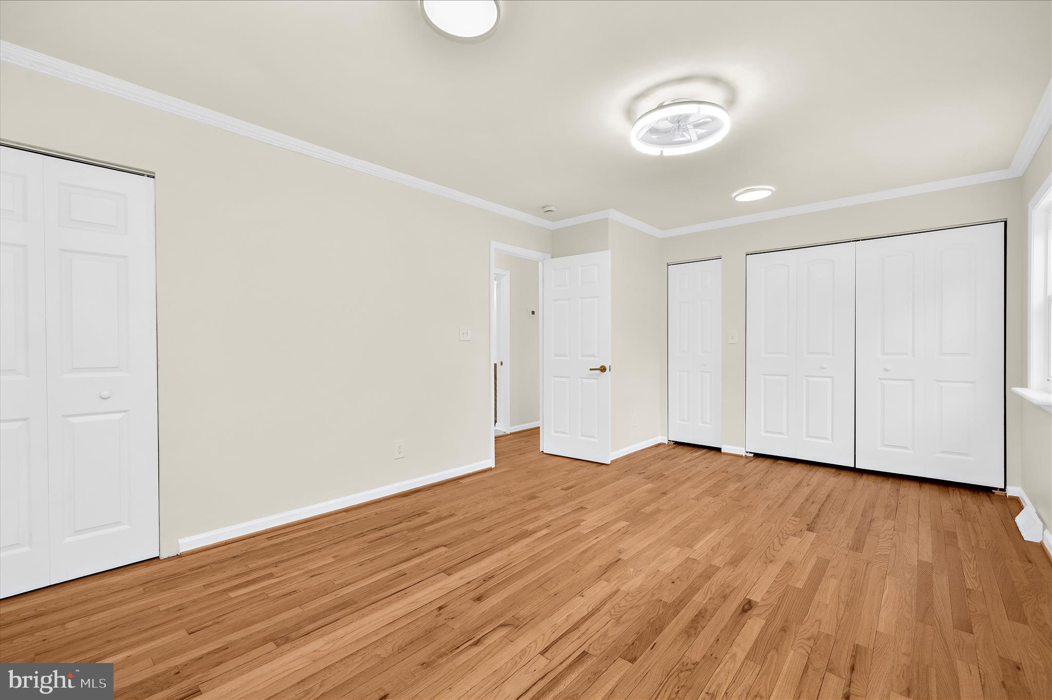 7831 Overhill Road Glen Burnie, MD 21060 - Photo 20 of 57 a view of an empty room with wooden floor and a window