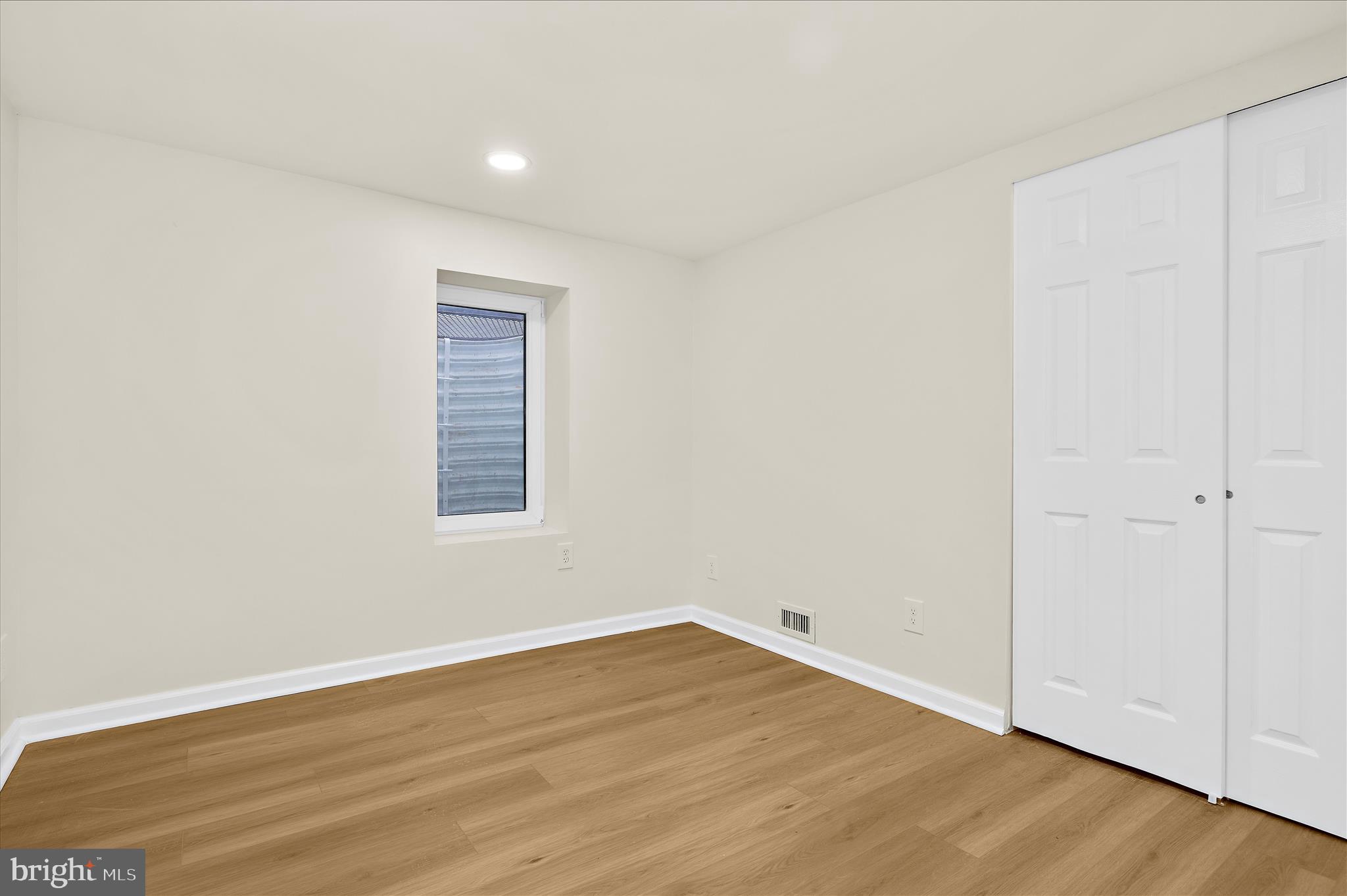 7831 Overhill Road Glen Burnie, MD 21060 - Photo 27 of 57 an empty room with wooden floor and windows