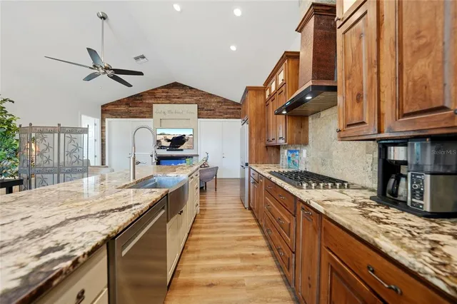 a kitchen with stainless steel appliances granite countertop a stove and a sink