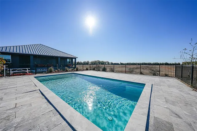 a view of swimming pool with outdoor seating