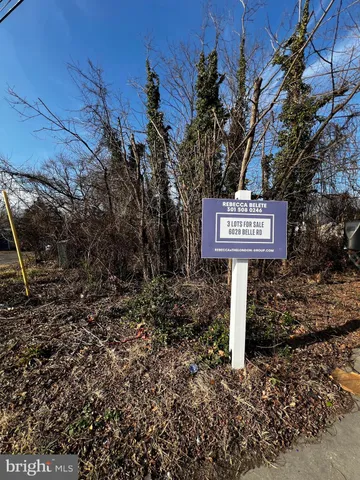 a sign board with wooden fence