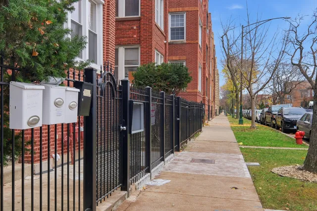 a front view of a building with a garden
