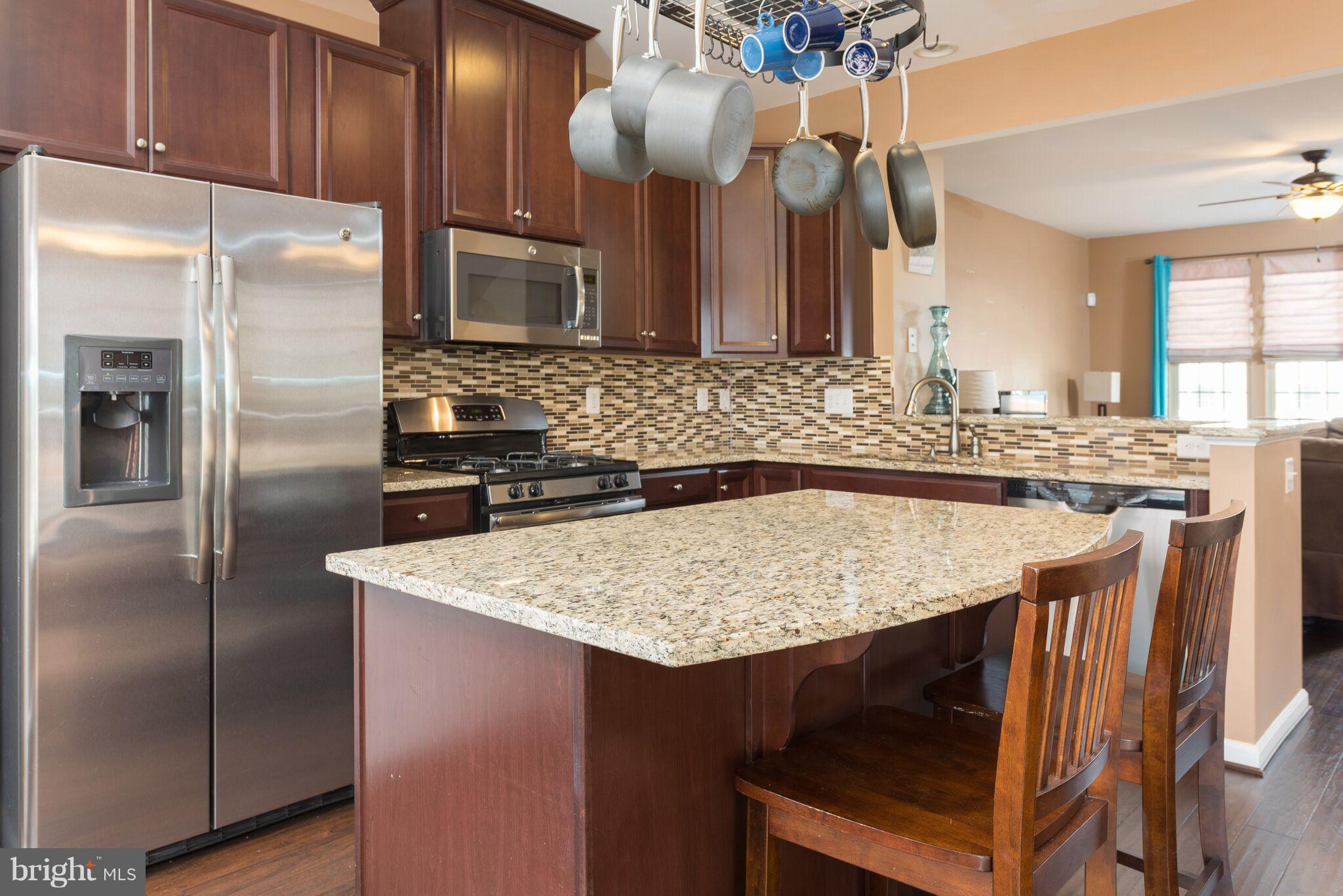 108 Brenton Road Fredericksburg, VA 22405 - Photo 12 of 24 a kitchen with stainless steel appliances granite countertop a table chairs and a refrigerator