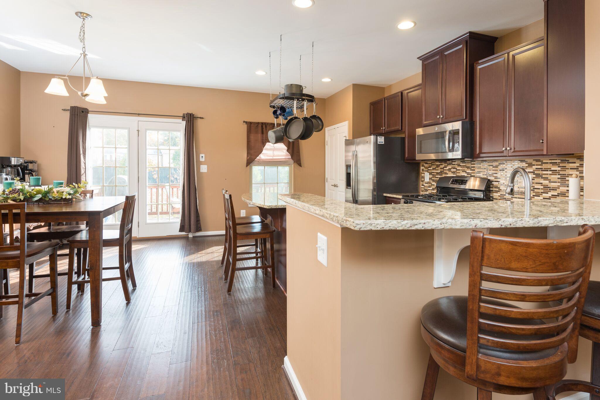 108 Brenton Road Fredericksburg, VA 22405 - Photo 8 of 24 a kitchen with stainless steel appliances granite countertop a table chairs stove and a window
