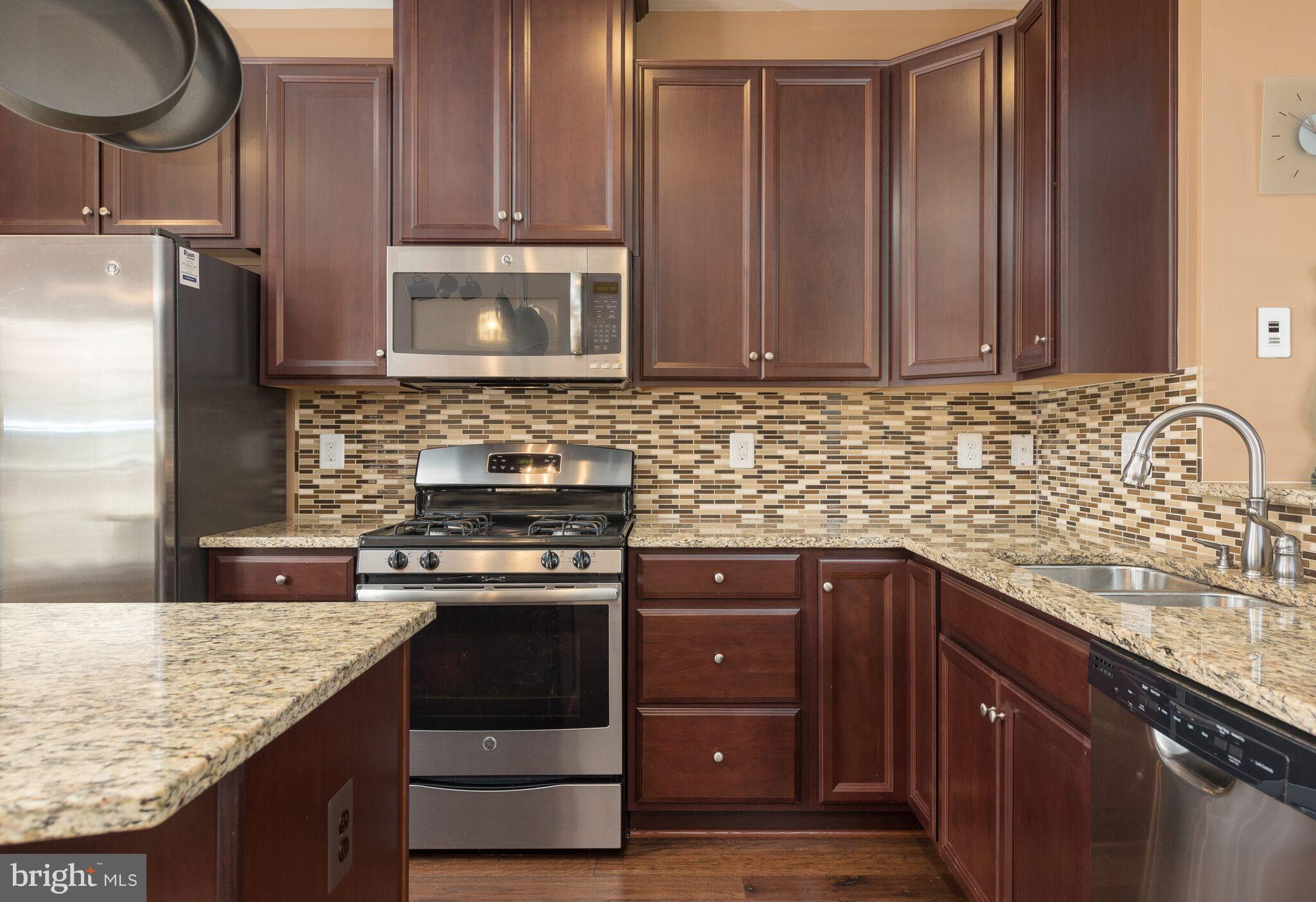 108 Brenton Road Fredericksburg, VA 22405 - Photo 10 of 24 a kitchen with stainless steel appliances granite countertop wooden cabinets and a stove top oven