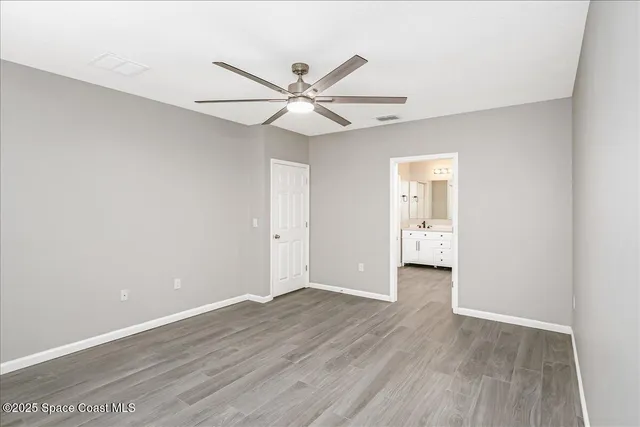 a view of an empty room and wooden floor
