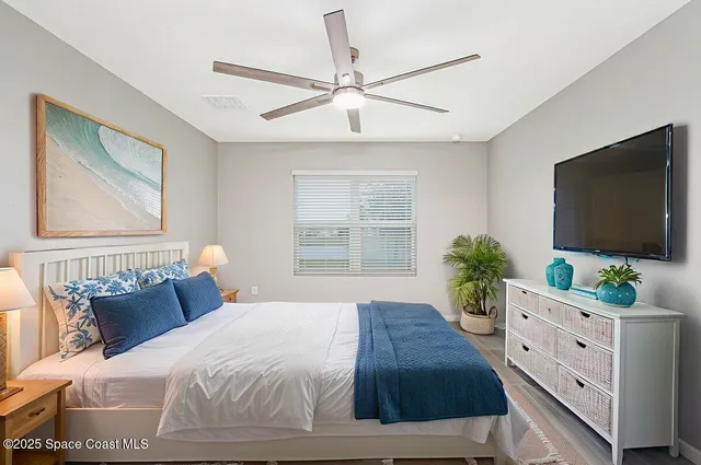 a bedroom with a bed and a flat screen tv