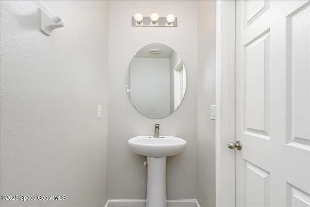 a bathroom with a sink a mirror and a shower