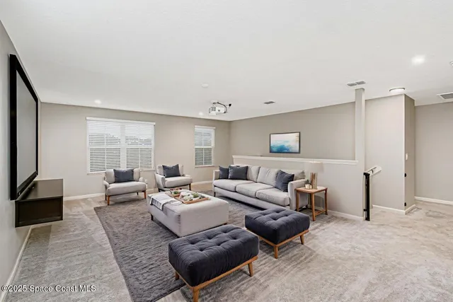 a living room with furniture window and a flat screen tv