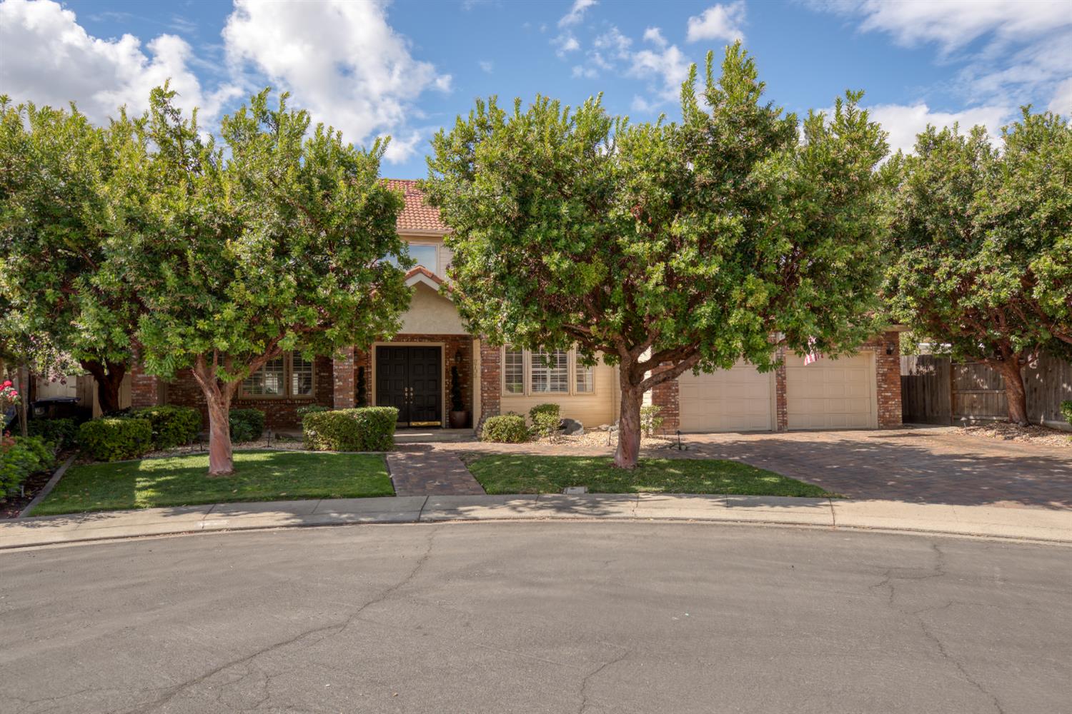2705 Lake Front Court Modesto, CA 95355 - Photo 1 of 50 a front view of a house with a yard and a garage