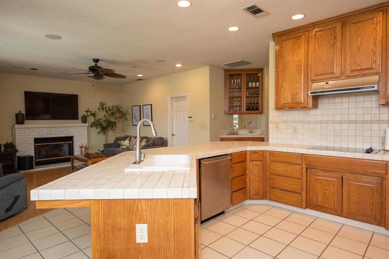 2705 Lake Front Court Modesto, CA 95355 - Photo 11 of 50 a kitchen with a sink a stove and a microwave