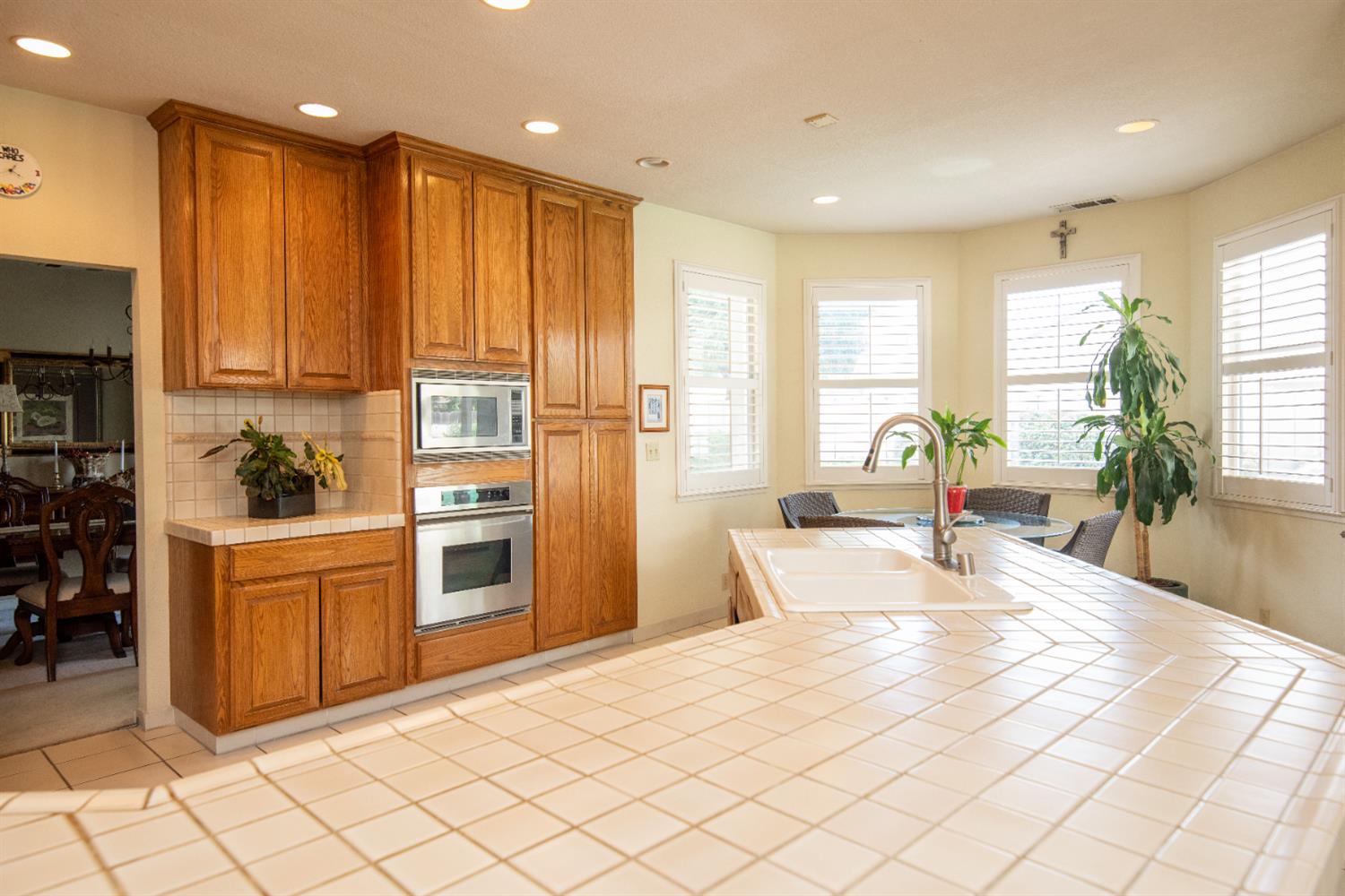 2705 Lake Front Court Modesto, CA 95355 - Photo 13 of 50 a large kitchen with kitchen island granite countertop a large counter top stainless steel appliances a sink a window and cabinets