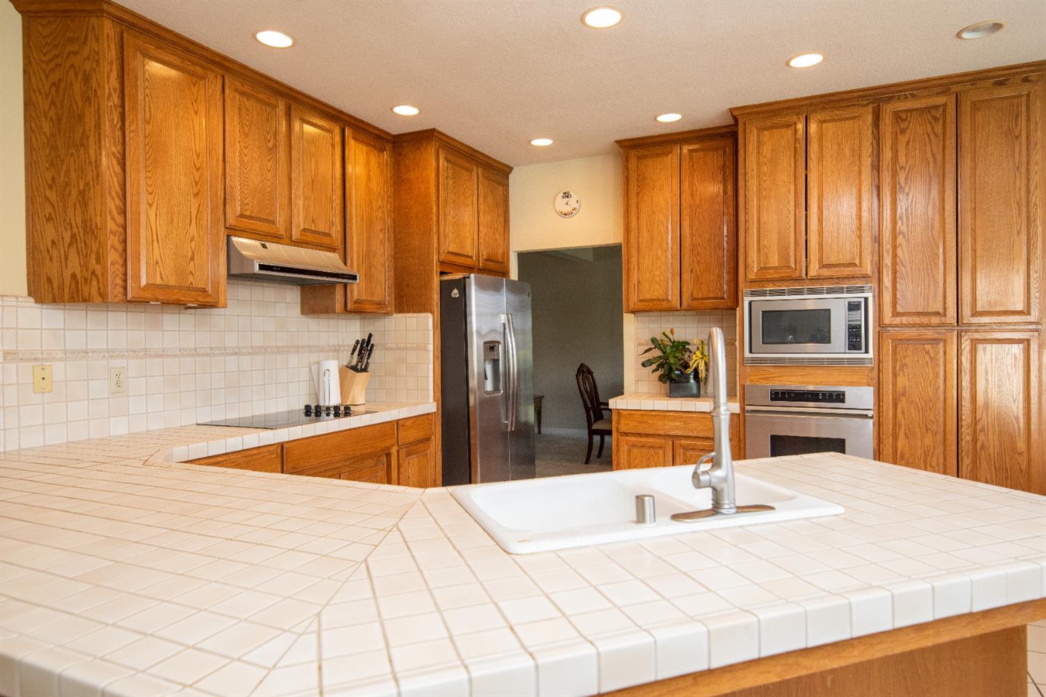 2705 Lake Front Court Modesto, CA 95355 - Photo 16 of 50 a kitchen with stainless steel appliances a refrigerator and wooden cabinets