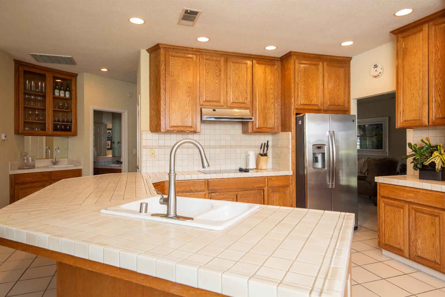 2705 Lake Front Court Modesto, CA 95355 - Photo 17 of 50 a kitchen with stainless steel appliances kitchen island granite countertop a refrigerator a stove and a sink with wooden cabinets