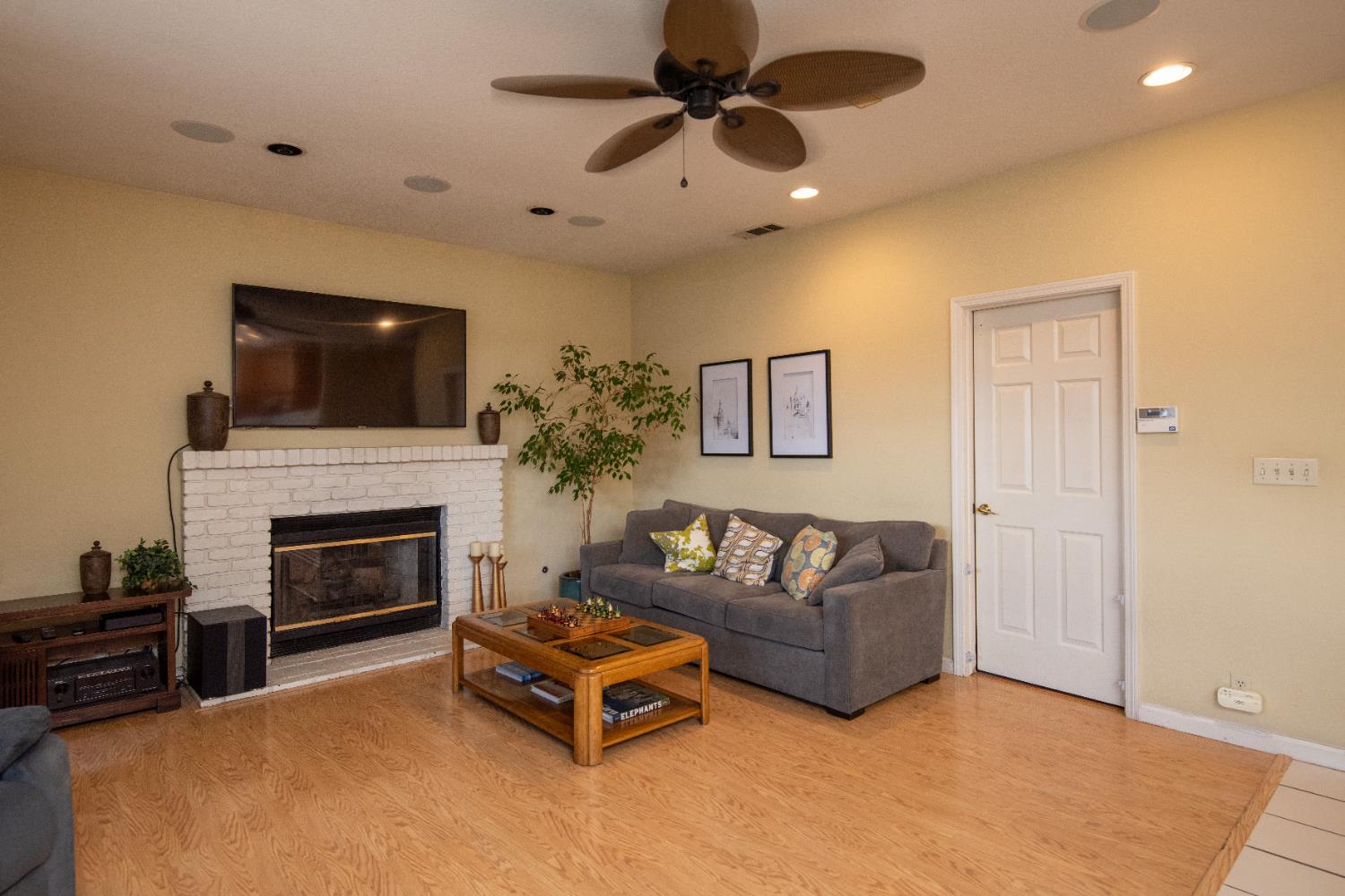 2705 Lake Front Court Modesto, CA 95355 - Photo 20 of 50 a living room with furniture a flat screen tv and a fireplace