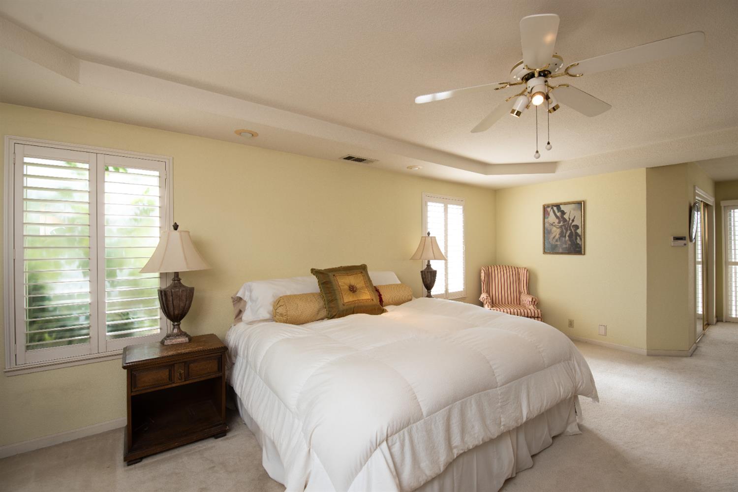 2705 Lake Front Court Modesto, CA 95355 - Photo 29 of 50 a bedroom with a bed large window and potted plant