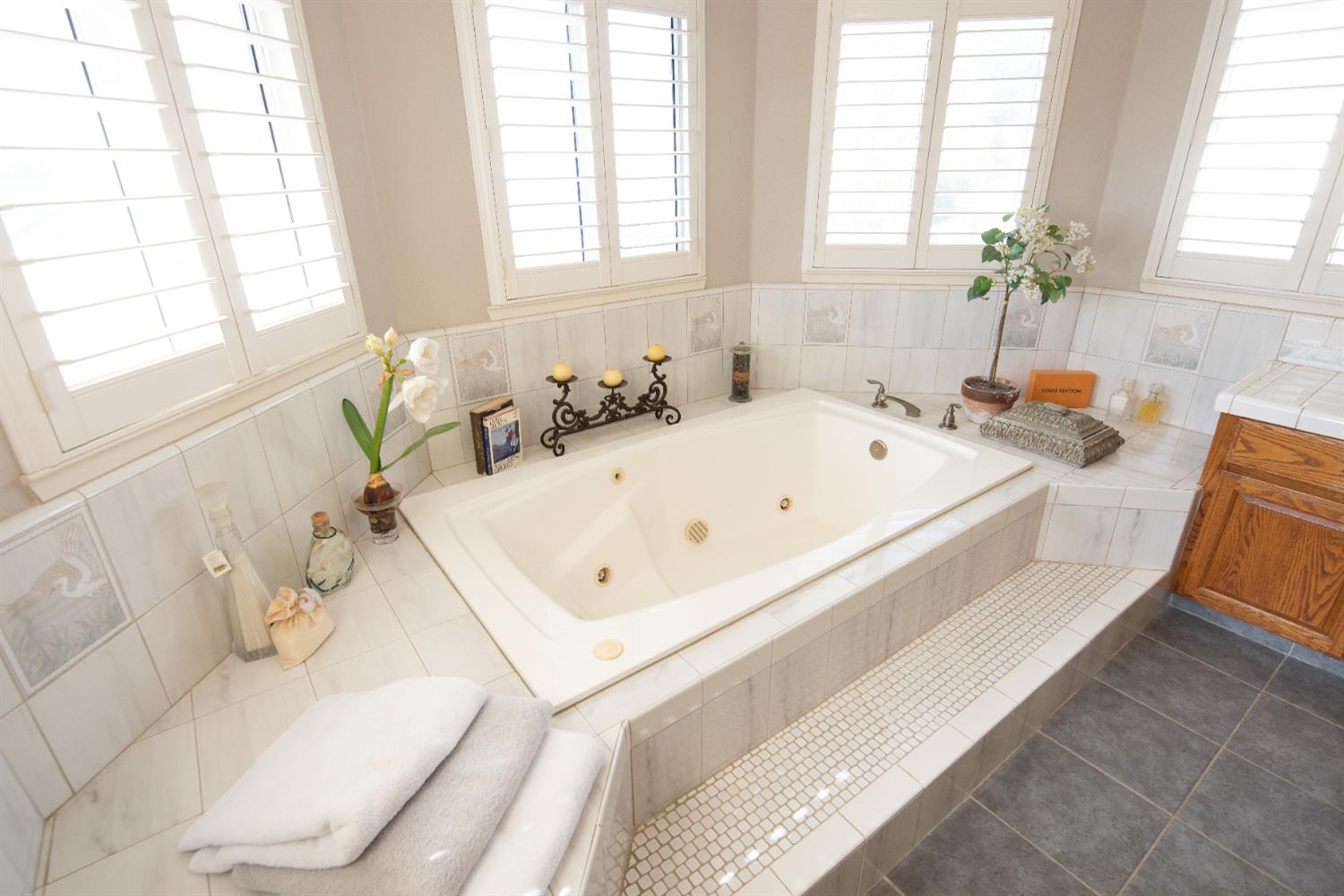 2705 Lake Front Court Modesto, CA 95355 - Photo 33 of 50 a bath tub sitting in a bathroom next to a window