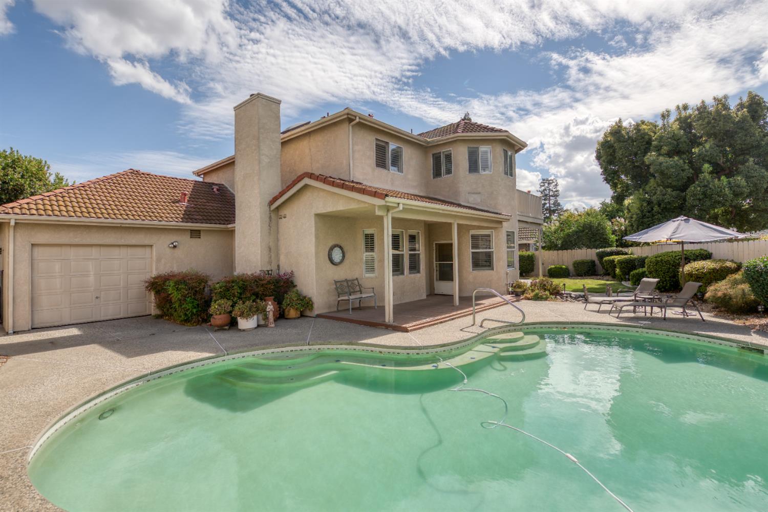 2705 Lake Front Court Modesto, CA 95355 - Photo 46 of 50 a view of a house with a yard patio and swimming pool