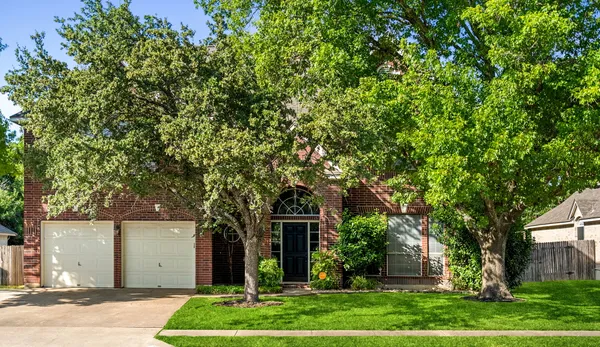 front view of a house with a tree