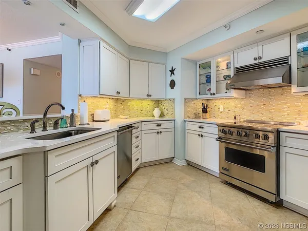a kitchen with cabinets appliances and a sink