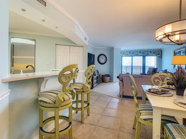 a living room with furniture a dining table and chairs