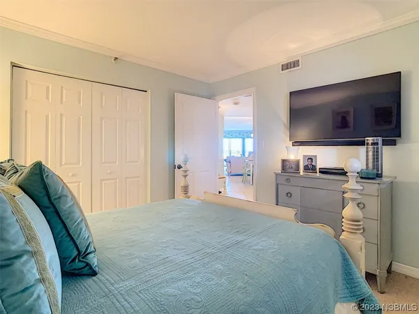 a bedroom with a bed and a flat screen tv